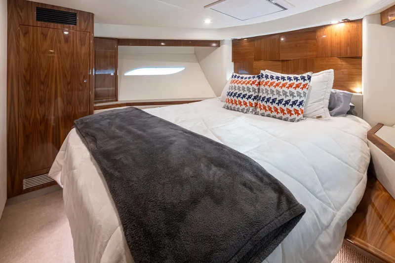 Slide: The Image of Luxurious 2017 Riviera Sport Cruiser cabin with cozy bedding and elegant wood paneling. - 46