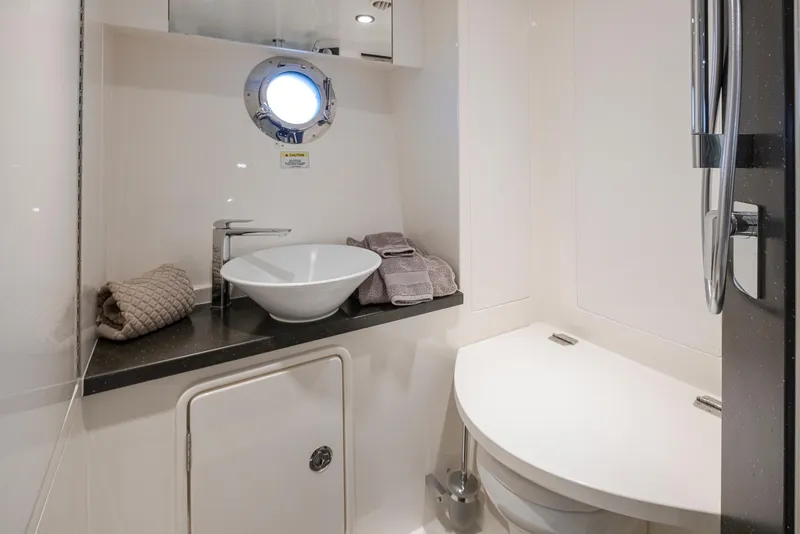 Slide: The Image of 2017 Riviera Sport Cruiser bathroom with modern sink, round window, and compact design. - 49