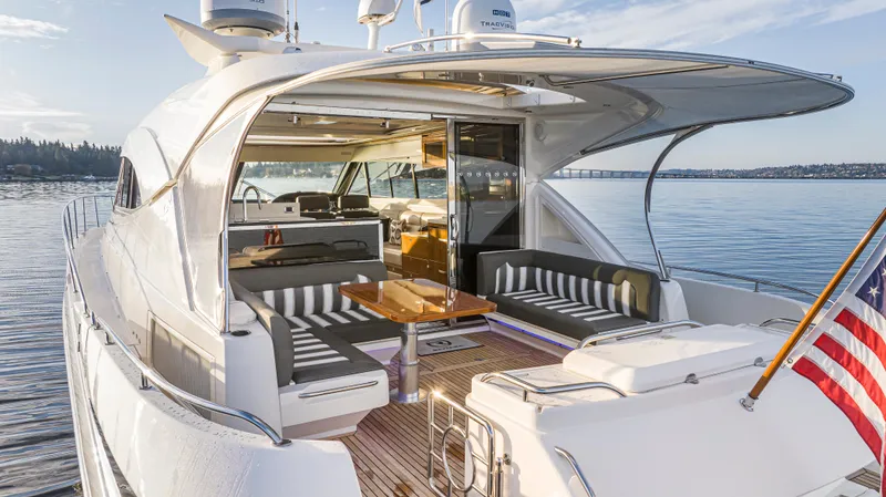 Slide: The Image of 2017 Riviera Sport Cruiser yacht with elegant seating, docked on calm waters. - 8