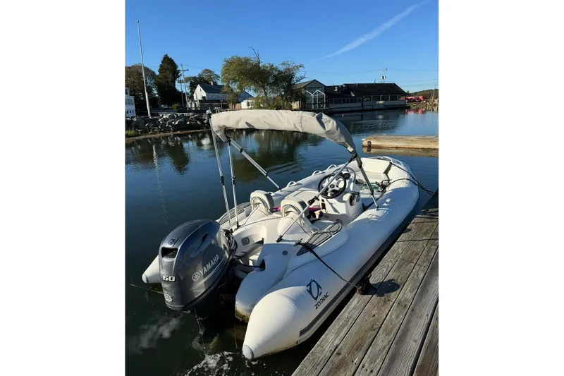 Slide: The Image of 2024 Zodiac Yachtline 440 inflatable boat docked with Yamaha outboard motor. - 3