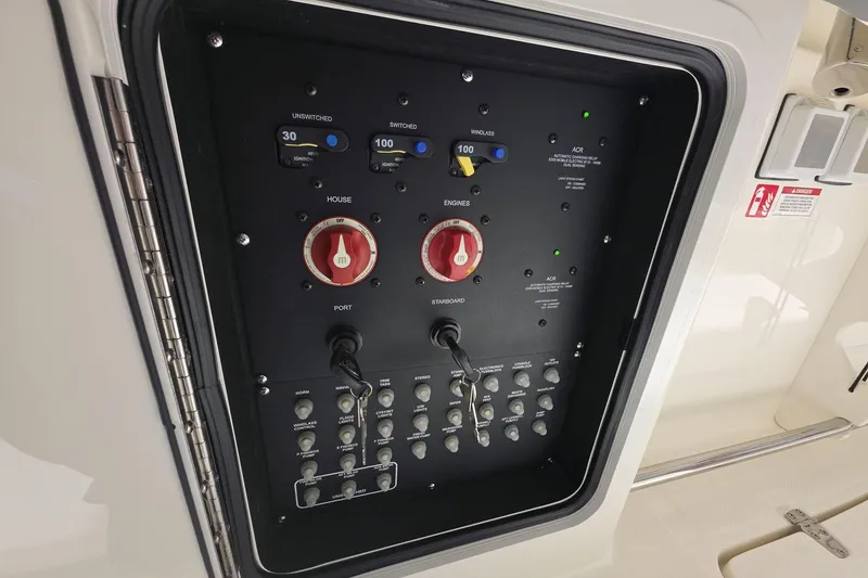 Slide: The Image of Electrical control panel on a 2026 Boston Whaler 330 Outrage boat. - 13