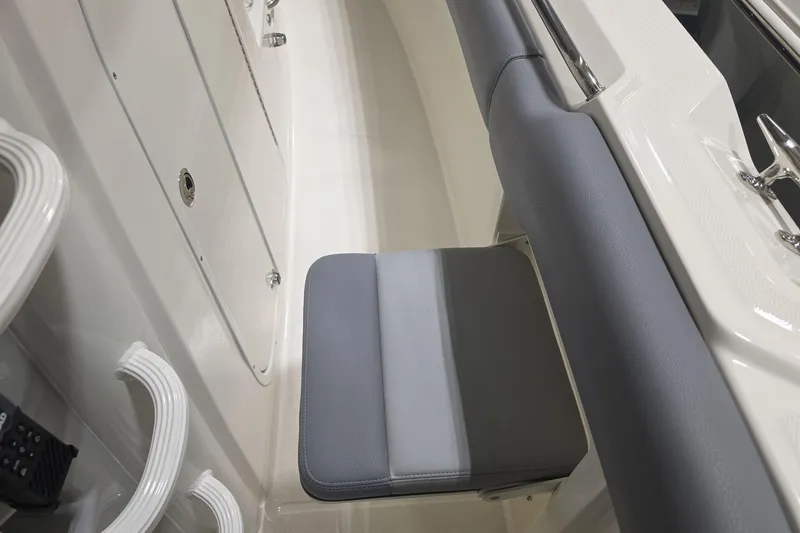Slide: The Image of 2026 Boston Whaler 330 Outrage interior seating detail with gray upholstery. - 19