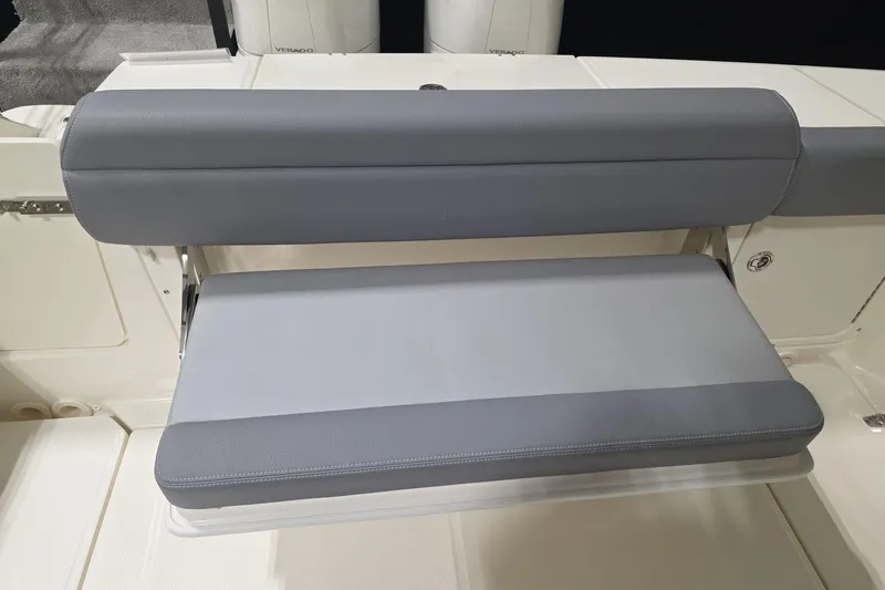 Slide: The Image of 2026 Boston Whaler 330 Outrage, gray cushioned seating detail on deck. - 21