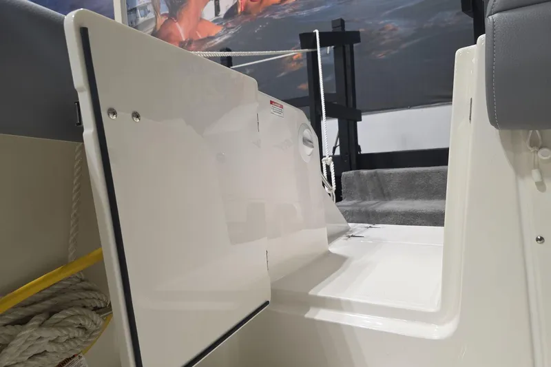 Slide: The Image of 2026 Boston Whaler 330 Outrage boat interior with open hatch and seating. - 25