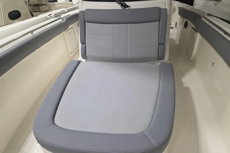 Slide: The Image of 2026 Boston Whaler 330 Outrage boat interior with cushioned seating. - 35