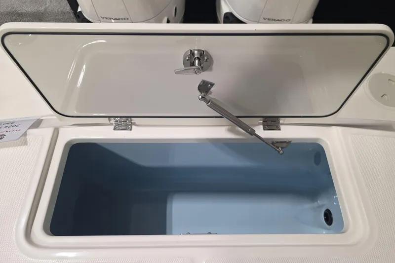 Slide: The Image of Open storage compartment on 2026 Boston Whaler 330 Outrage boat, showcasing interior design. - 40
