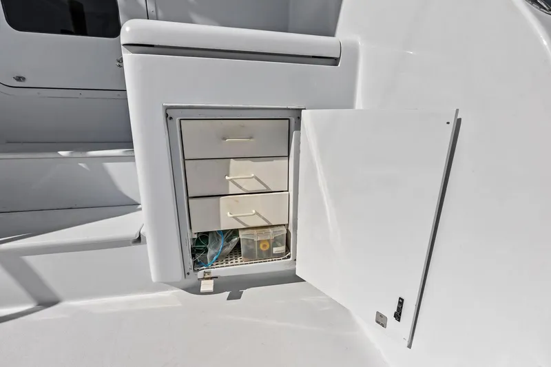 Slide: The Image of Storage compartment on 2003 Hatteras 65 Convertible yacht with open door and drawers. - 13