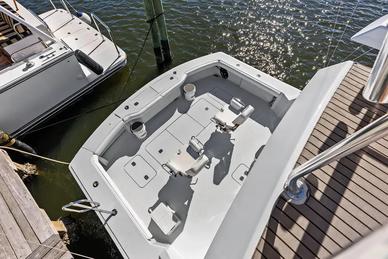 Slide: The Image of 2003 Hatteras 65 Convertible yacht cockpit, docked, with fishing chairs and rod holders. - 16
