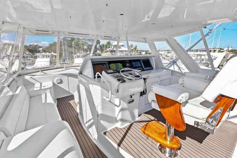 Slide: The Image of 2003 Hatteras 65 Convertible yacht cockpit with modern navigation equipment and luxurious seating. - 18