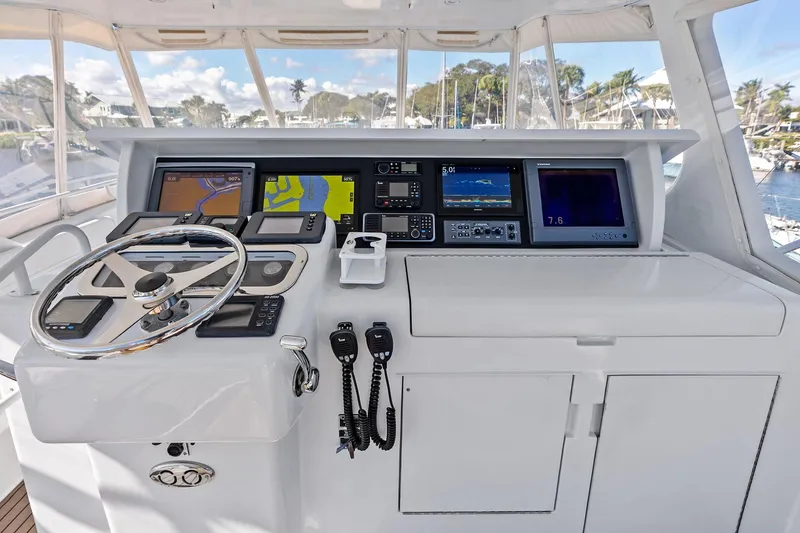 Slide: The Image of Helm of 2003 Hatteras 65 Convertible yacht with advanced navigation equipment. - 19