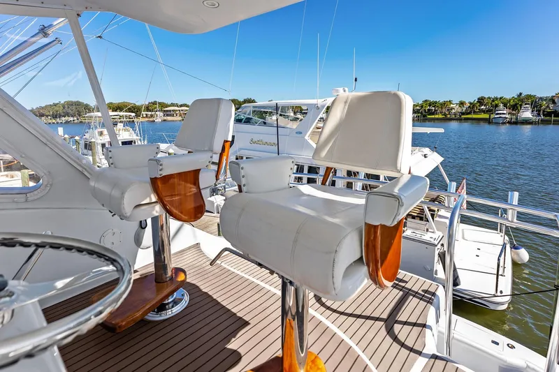 Slide: The Image of Luxury seating on 2003 Hatteras 65 Convertible yacht, overlooking marina. - 22