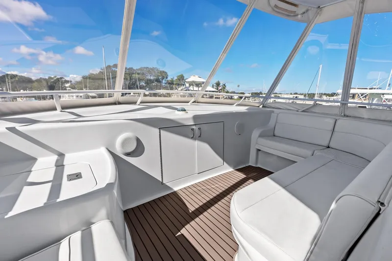 Slide: The Image of Luxurious interior of 2003 Hatteras 65 Convertible yacht with white seating and wood flooring. - 24