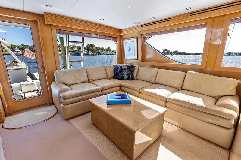 Slide: The Image of Luxurious interior of 2003 Hatteras 65 Convertible yacht with beige leather seating and waterfront view. - 29