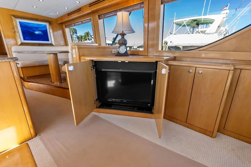 Slide: The Image of Luxurious interior of 2003 Hatteras 65 Convertible yacht with hidden TV cabinet. - 30