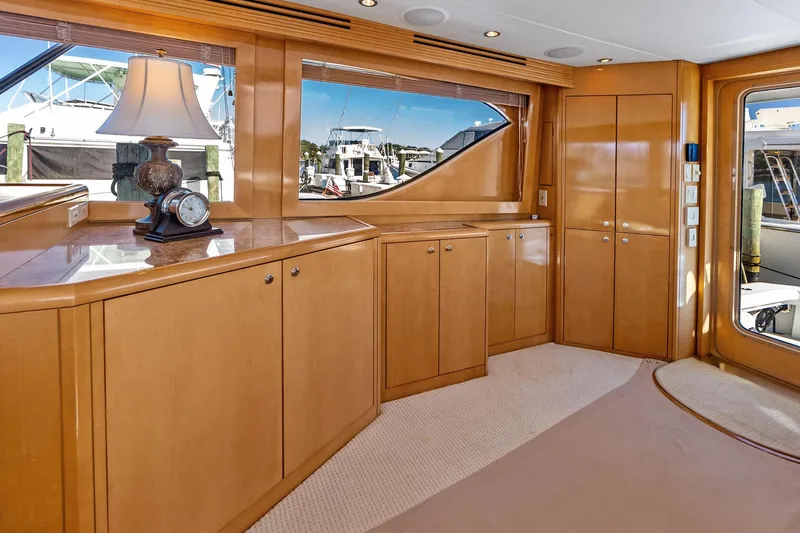 Slide: The Image of Luxurious interior of 2003 Hatteras 65 Convertible yacht with wooden cabinetry and elegant decor. - 32