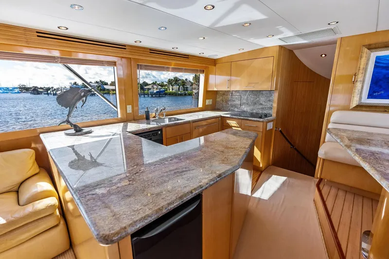 Slide: The Image of Luxurious interior of 2003 Hatteras 65 Convertible yacht with modern kitchen and scenic views. - 36