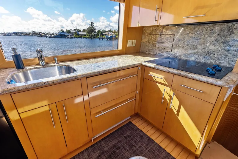 Slide: The Image of Luxurious kitchen interior of 2003 Hatteras 65 Convertible yacht with scenic water view. - 37