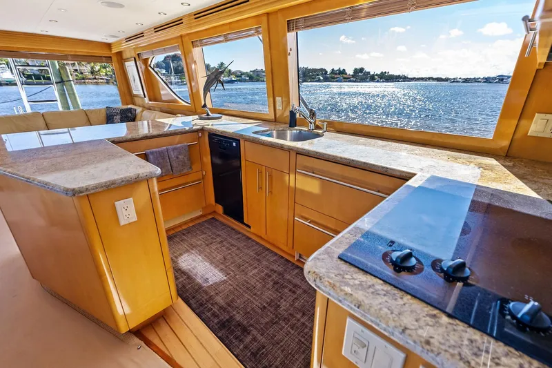 Slide: The Image of Luxurious kitchen interior of 2003 Hatteras 65 Convertible yacht with ocean view. - 38