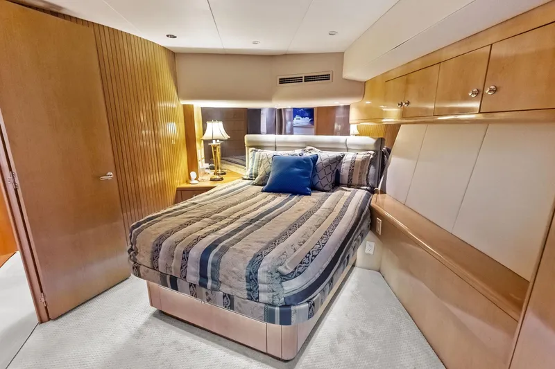 Slide: The Image of Luxurious bedroom interior of 2003 Hatteras 65 Convertible yacht with elegant wood finishes. - 46