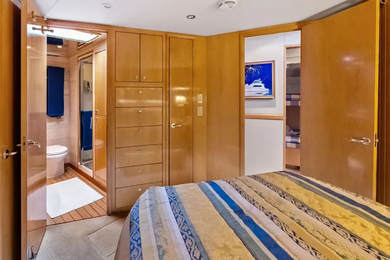 Slide: The Image of Luxurious 2003 Hatteras 65 Convertible yacht interior with wood paneling and ensuite bathroom. - 47