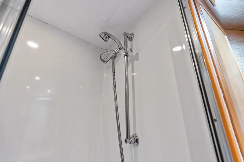 Slide: The Image of Shower area in 2003 Hatteras 65 Convertible yacht, featuring chrome fixtures. - 49