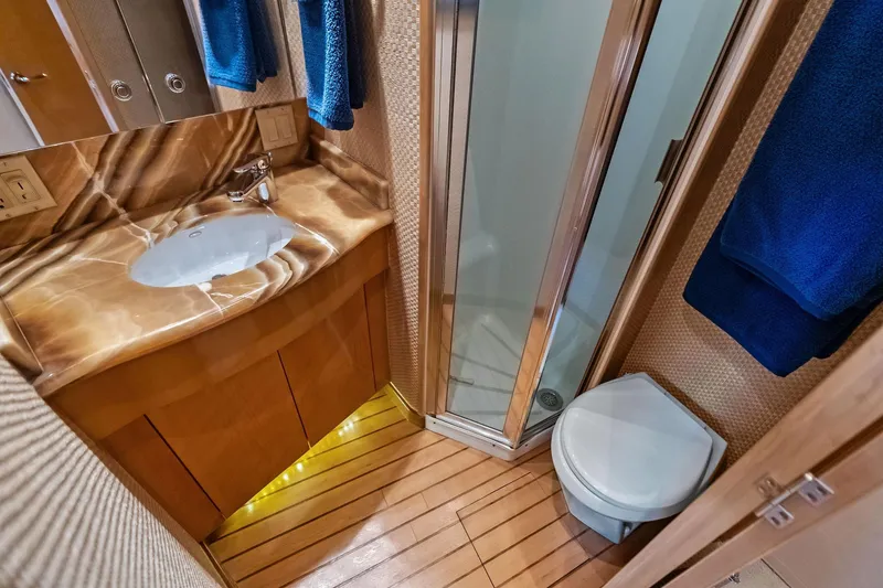 Slide: The Image of Luxurious bathroom in 2003 Hatteras 65 Convertible yacht with marble sink and shower. - 50