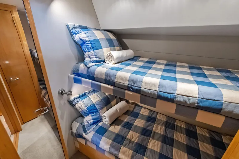 Slide: The Image of Bunk beds with blue checkered bedding in 2003 Hatteras 65 Convertible yacht cabin. - 51