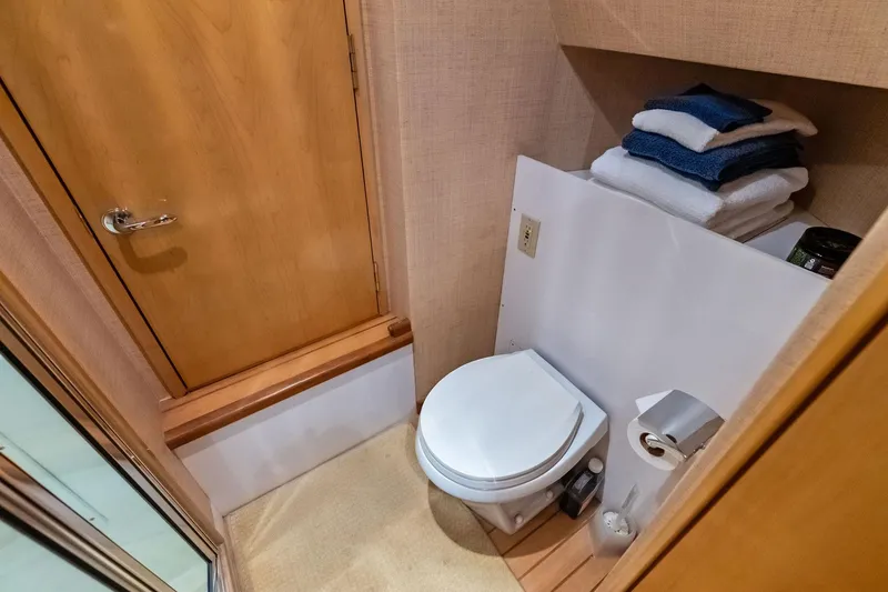Slide: The Image of Bathroom interior of 2003 Hatteras 65 Convertible yacht with toilet and towels. - 58