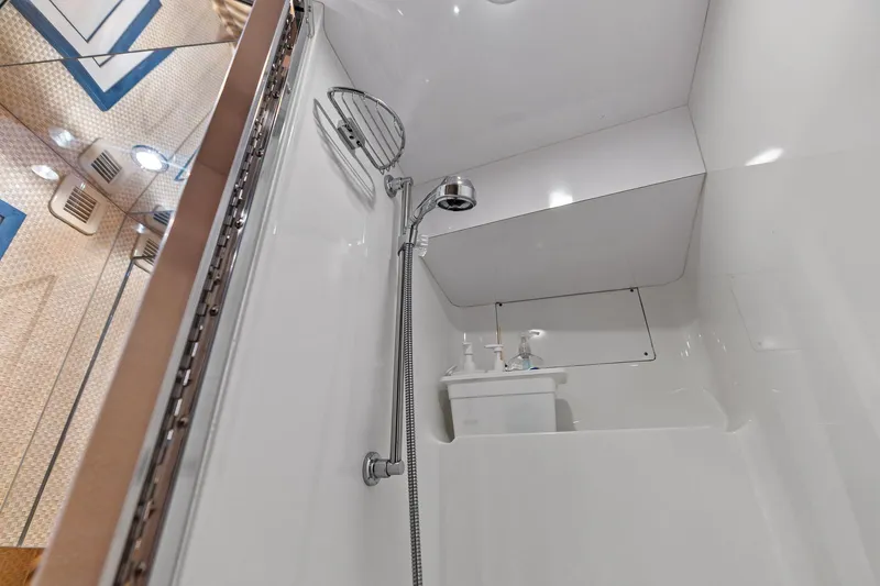 Slide: The Image of Shower area in 2003 Hatteras 65 Convertible yacht, featuring modern fixtures and sleek design. - 60