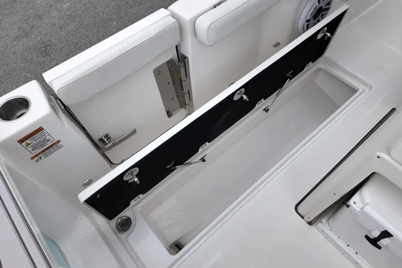 Slide: The Image of 2026 Sea Fox 288 Commander boat storage compartment with open hatch and seating. - 14