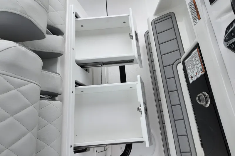 Slide: The Image of 2026 Sea Fox 288 Commander interior with open storage compartments and quilted seating. - 24