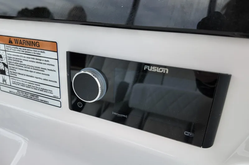 Slide: The Image of Control panel on 2026 Sea Fox 288 Commander boat with warning label and Fusion audio system. - 26