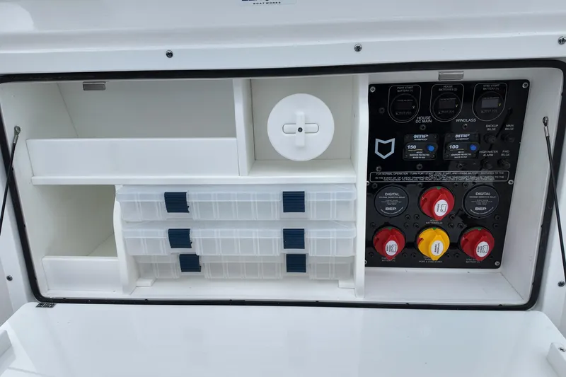 Slide: The Image of 2026 Sea Fox 288 Commander electrical panel with storage compartments and control switches. - 30
