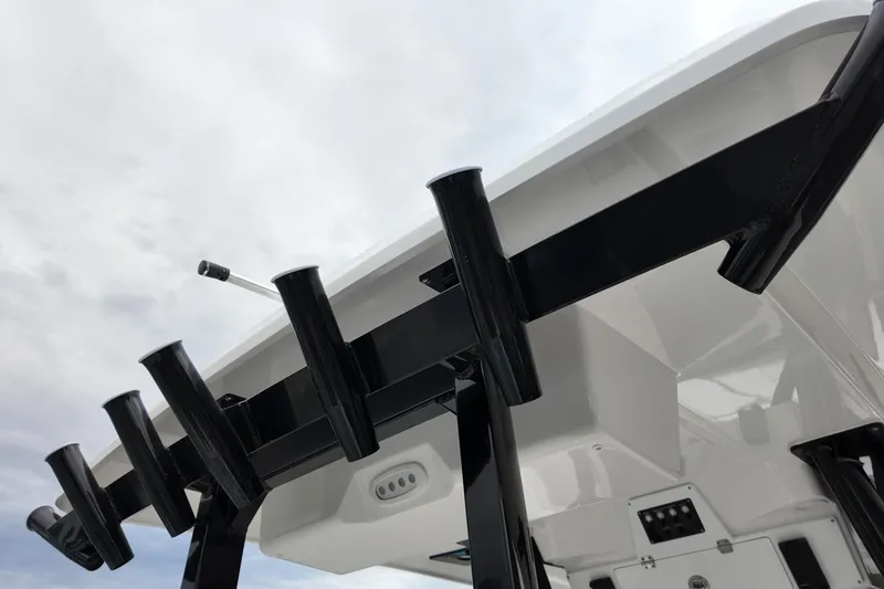 Slide: The Image of 2026 Sea Fox 288 Commander boat with rod holders against cloudy sky. - 4