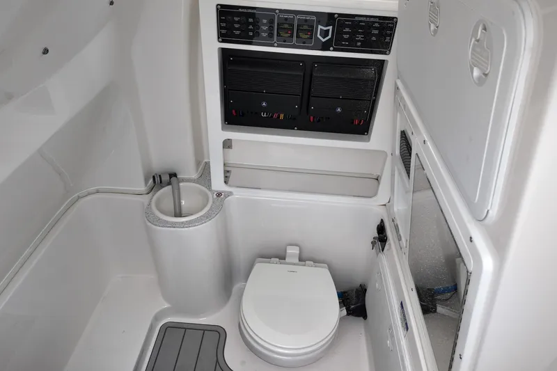 Slide: The Image of Interior of 2026 Sea Fox 288 Commander boat bathroom with toilet and control panels. - 6