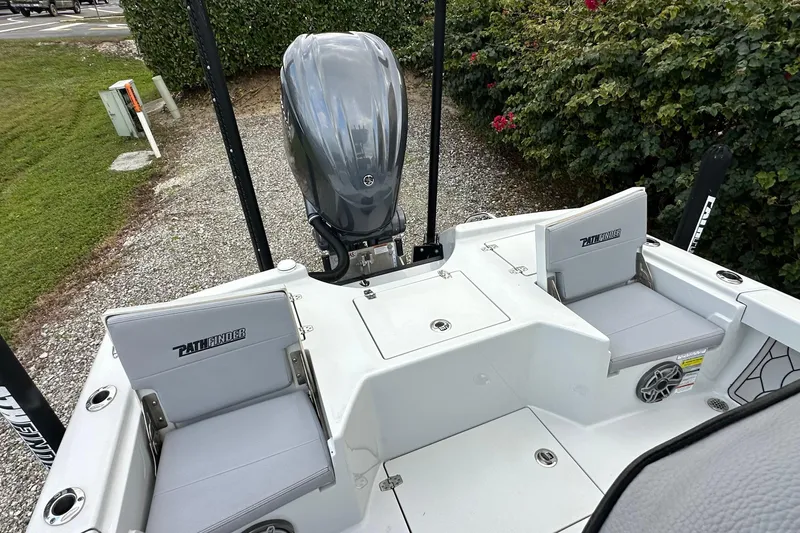 Slide: The Image of 2023 Pathfinder 2500 Hybrid boat with seating and outboard motor, parked on gravel. - 10