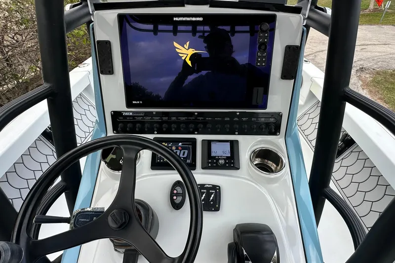 Slide: The Image of 2023 Pathfinder 2500 Hybrid boat dashboard with steering wheel and electronic controls. - 12