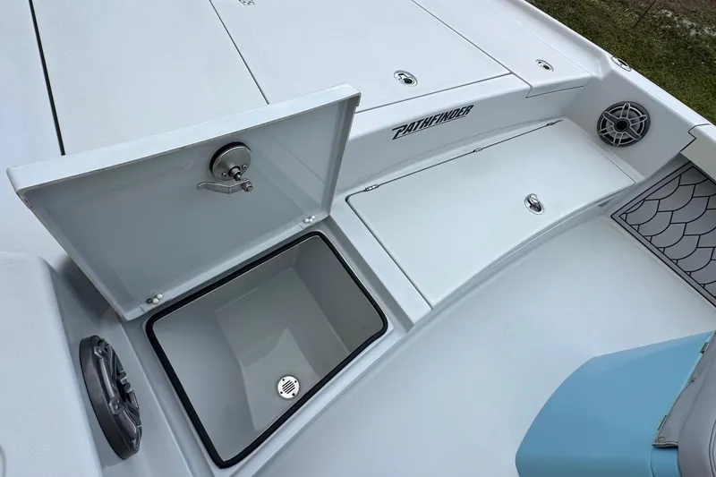 Slide: The Image of 2023 Pathfinder 2500 Hybrid boat deck with open storage compartment and speaker. - 15
