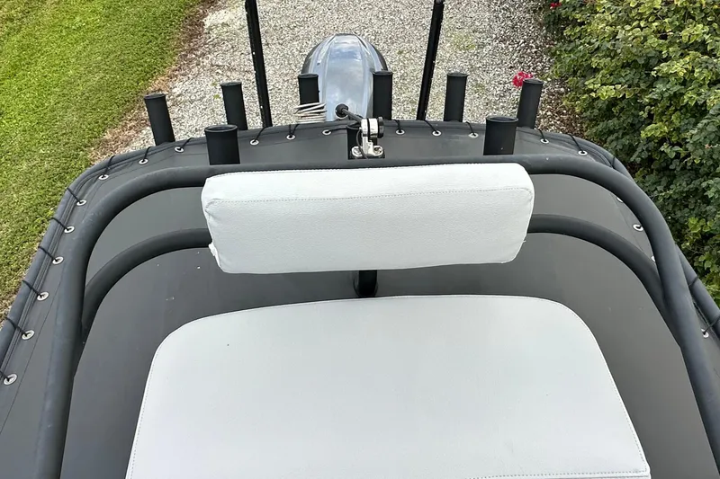 Slide: The Image of 2023 Pathfinder 2500 Hybrid boat interior with cushioned seating and rod holders. - 19