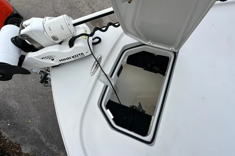 Slide: The Image of 2023 Pathfinder 2500 Hybrid boat with Minn Kota trolling motor and open storage hatch. - 23