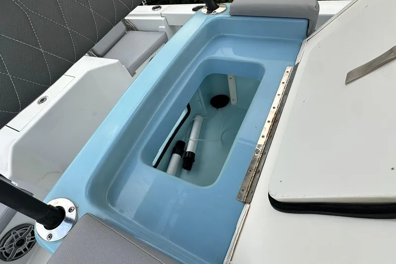 Slide: The Image of 2023 Pathfinder 2500 Hybrid boat interior with open storage compartment. - 26