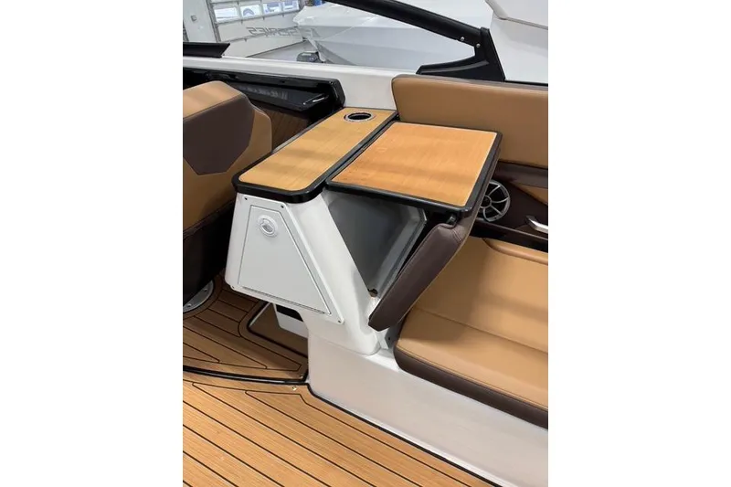 Slide: The Image of 2025 Yamaha Boats 252SE interior with wood accents and tan seating. - 10