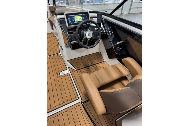 Slide: The Image of 2025 Yamaha Boats 252SE cockpit with modern controls and luxurious seating. - 15