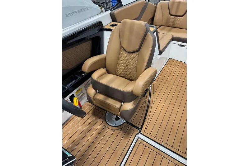 Slide: The Image of 2025 Yamaha Boats 252SE interior with luxurious tan seating and wood-style flooring. - 16