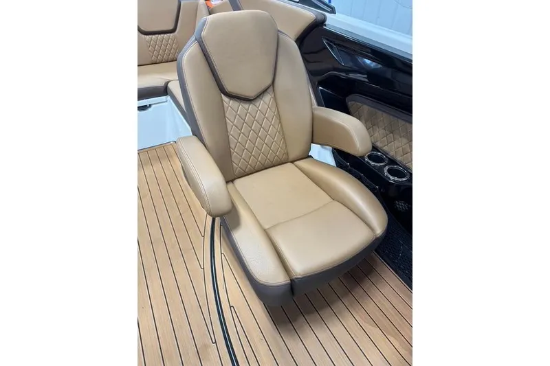 Slide: The Image of Luxurious tan seating on 2025 Yamaha Boats 252SE, featuring diamond stitching and armrests. - 17