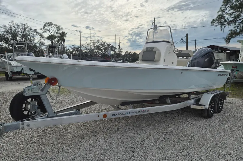 The Image of 2026 Key West 210 Bay Reef boat on trailer, parked outdoors under cloudy sky. - 1