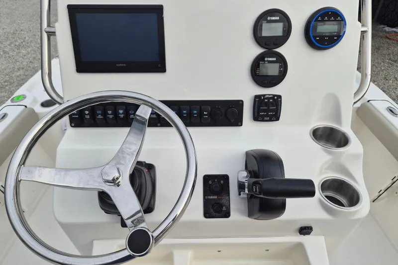 Slide: The Image of 2026 Key West 210 Bay Reef boat dashboard with steering wheel and control panel. - 12