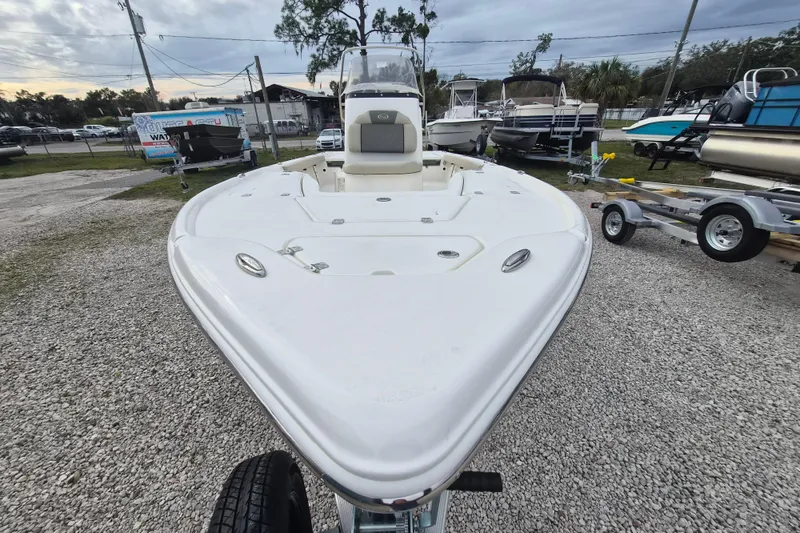 Slide: The Image of 2026 Key West 210 Bay Reef boat on gravel lot, surrounded by other boats. - 18