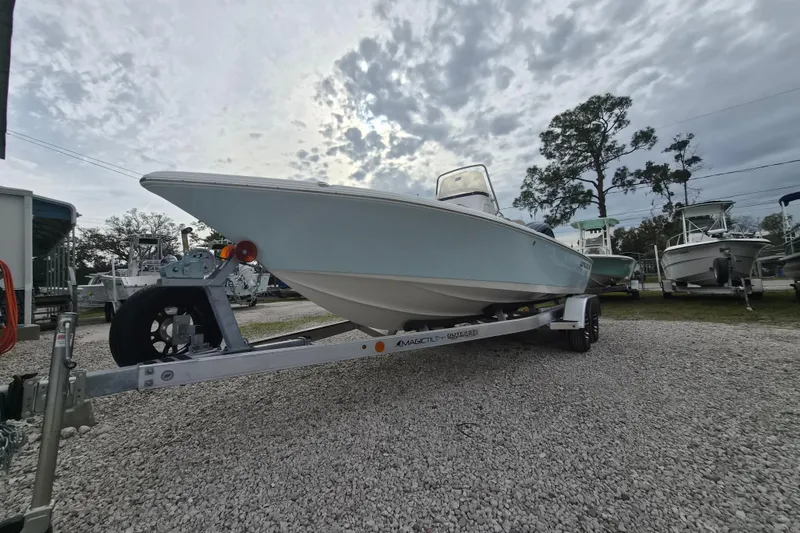Slide: The Image of 2026 Key West 210 Bay Reef boat on trailer under cloudy sky. - 19