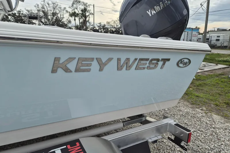 Slide: The Image of 2026 Key West 210 Bay Reef boat with Yamaha engine, parked on a trailer. - 20